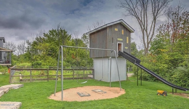 view of jungle gym featuring a yard and fence