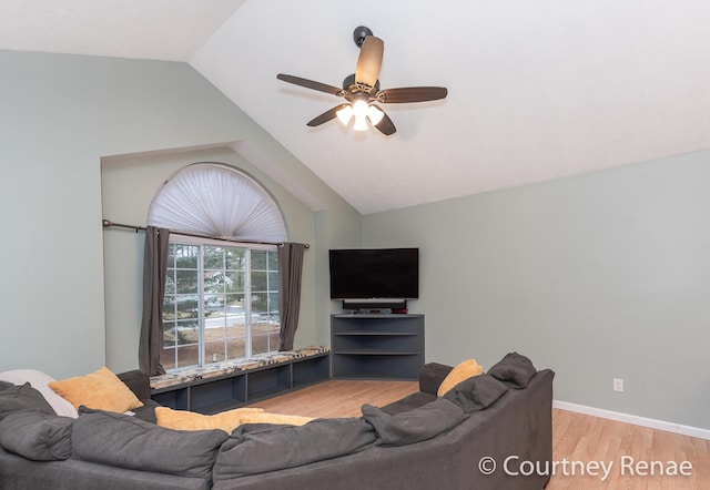 living area featuring lofted ceiling, wood finished floors, a ceiling fan, and baseboards