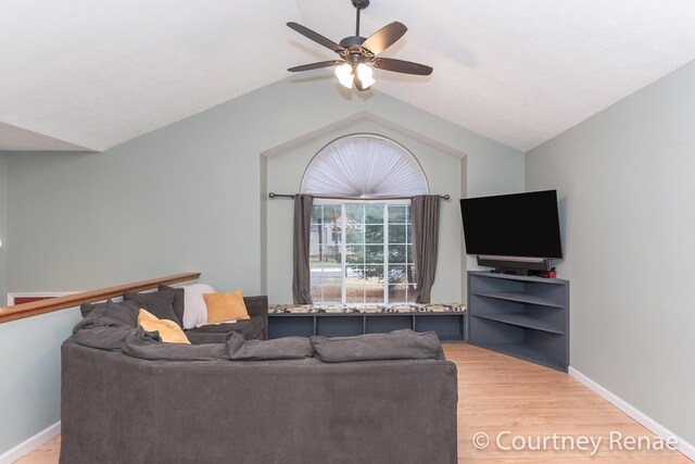 living area with light wood finished floors, baseboards, vaulted ceiling, and a ceiling fan