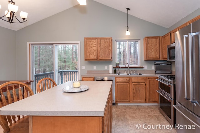 kitchen featuring a chandelier, stainless steel appliances, a sink, light countertops, and a wealth of natural light