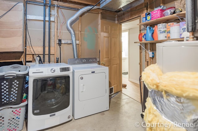 washroom with washing machine and dryer and laundry area