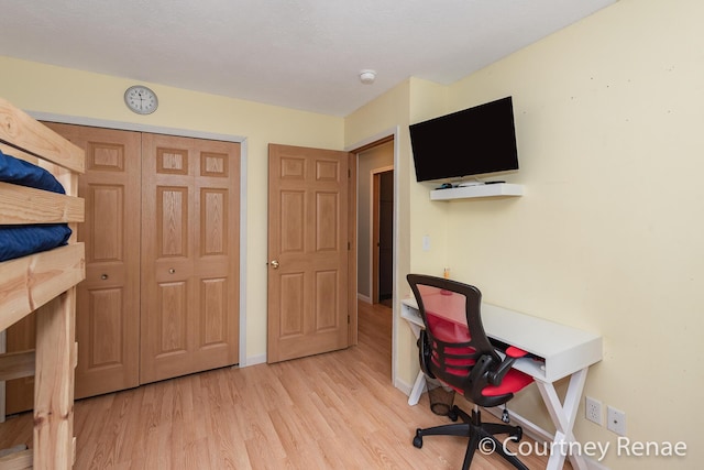 home office with baseboards and wood finished floors