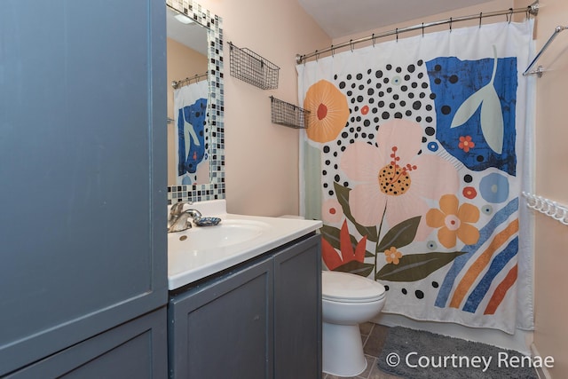 bathroom featuring a shower with curtain, vanity, toilet, and tile patterned floors