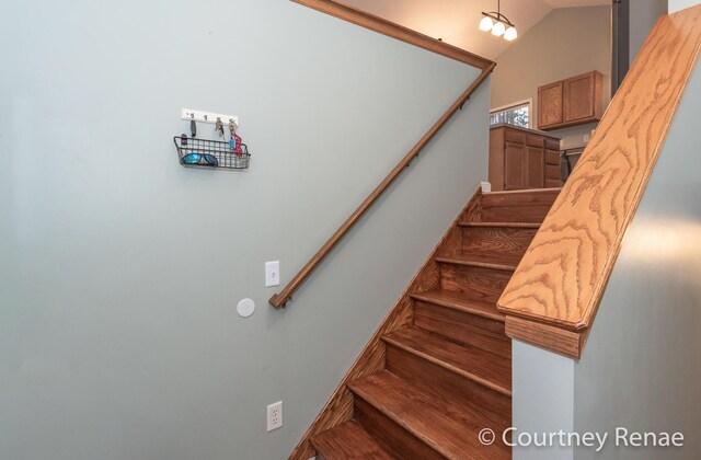 stairway featuring lofted ceiling