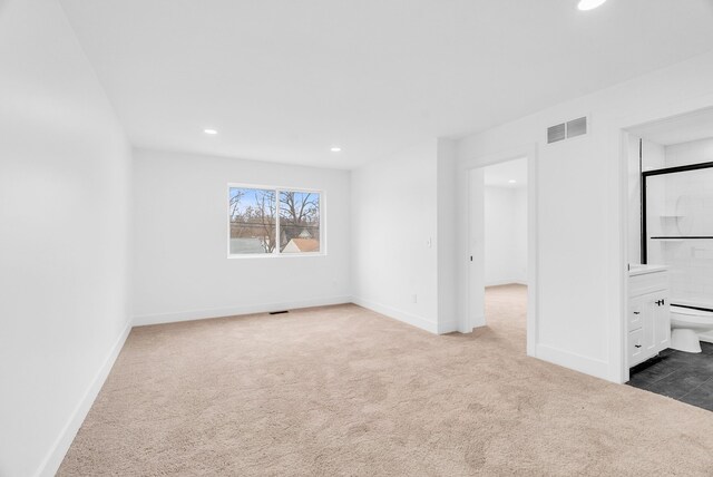 unfurnished bedroom featuring carpet floors, baseboards, visible vents, and recessed lighting