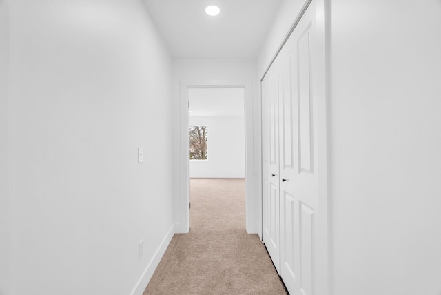 corridor with carpet floors and baseboards