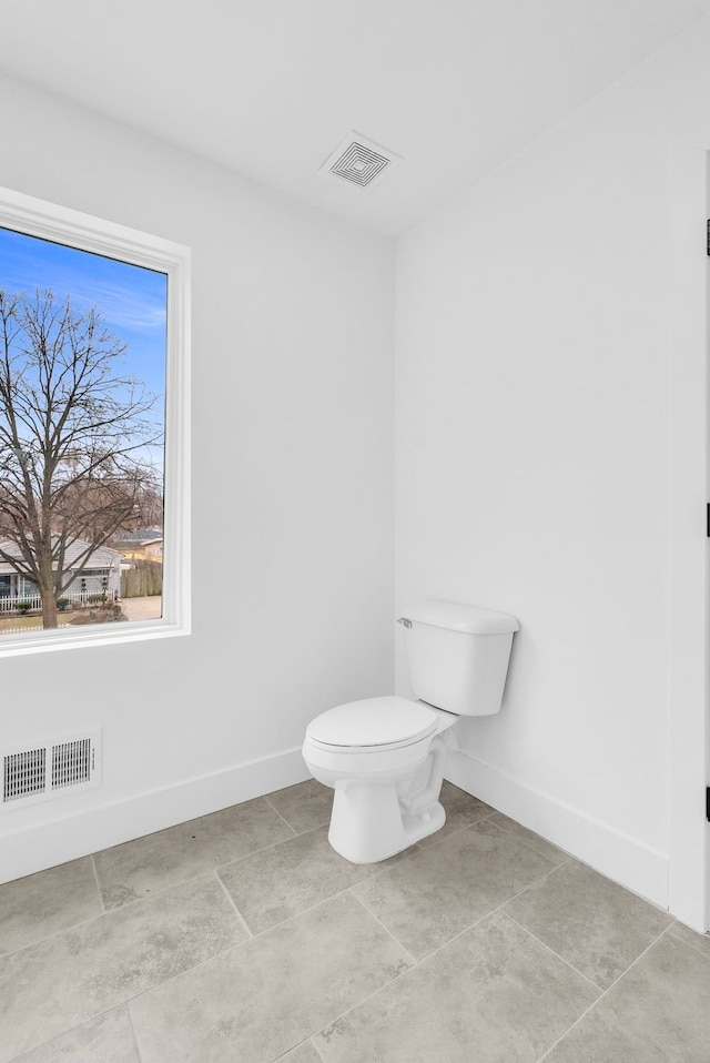 bathroom with toilet, baseboards, and visible vents