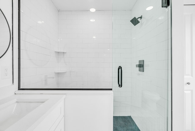 full bath featuring a stall shower and vanity