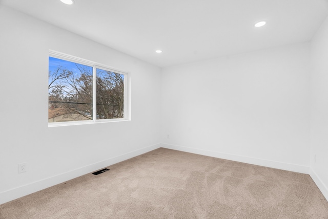 empty room featuring recessed lighting, carpet flooring, visible vents, and baseboards