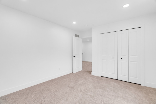 unfurnished bedroom featuring carpet, visible vents, baseboards, and recessed lighting