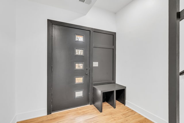 interior space featuring light wood-style flooring, visible vents, and baseboards