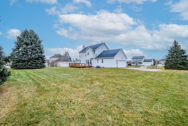 view of yard featuring a deck and a garage