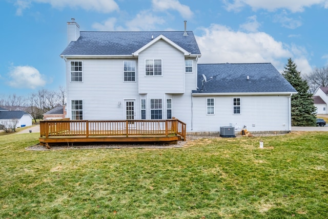 rear view of house featuring a shingled roof, cooling unit, a lawn, and a chimney