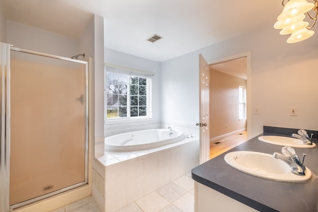 full bathroom with a stall shower, visible vents, a sink, and a bath