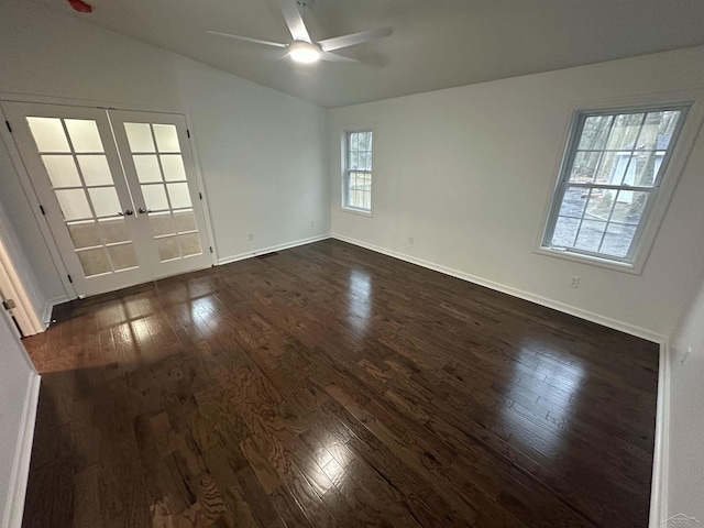 unfurnished room with french doors, dark wood-style flooring, a ceiling fan, vaulted ceiling, and baseboards