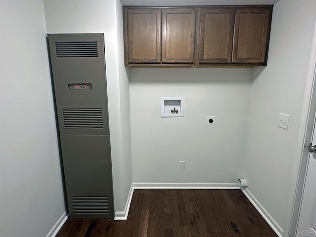 laundry area featuring baseboards, a heating unit, dark wood finished floors, hookup for a washing machine, and electric dryer hookup