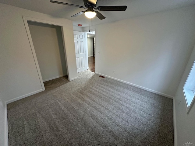 unfurnished bedroom featuring visible vents, baseboards, ceiling fan, carpet flooring, and a closet