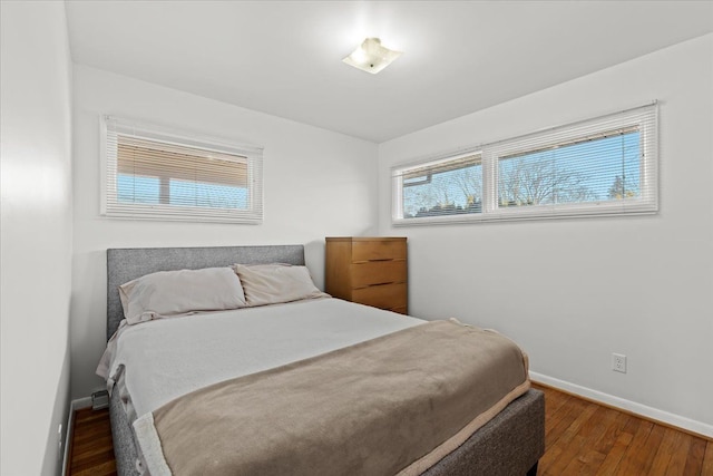 bedroom with baseboards and wood finished floors