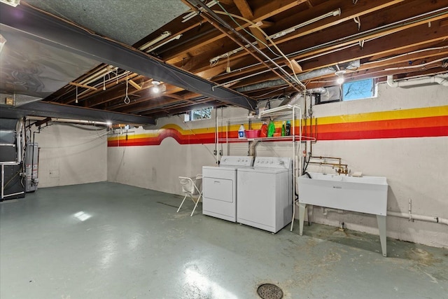 below grade area with gas water heater, independent washer and dryer, and a sink