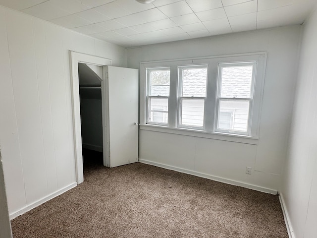 unfurnished bedroom with baseboards and carpet flooring