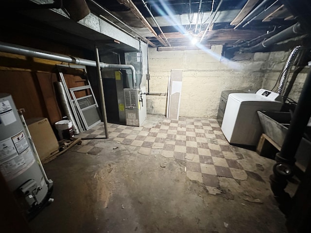 unfinished basement featuring water heater and separate washer and dryer