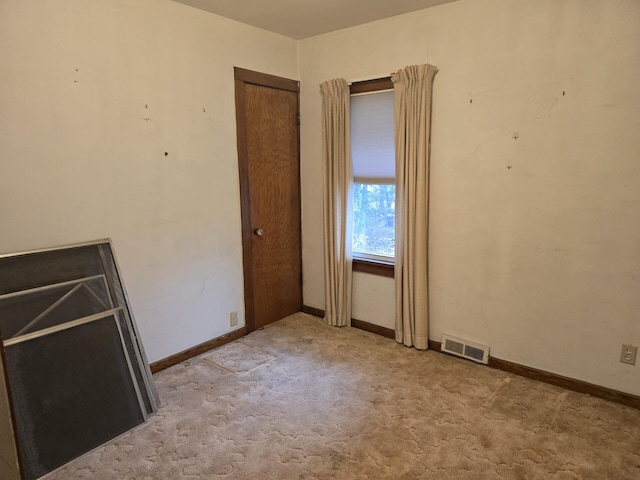 unfurnished bedroom featuring baseboards, visible vents, and carpet flooring