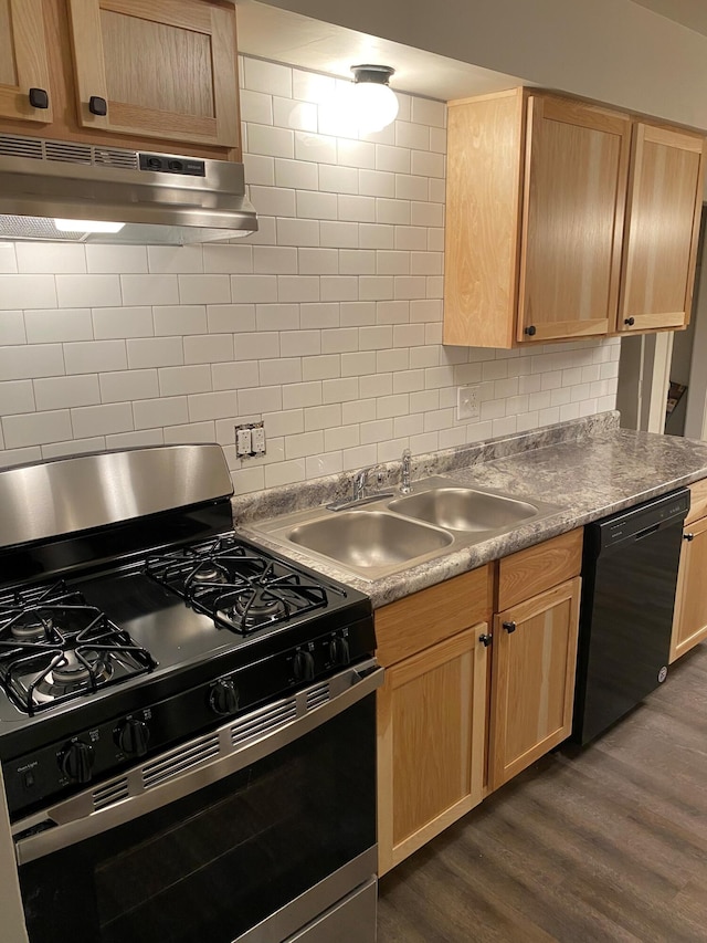 kitchen featuring black dishwasher, gas range, dark wood-style floors, under cabinet range hood, and light brown cabinets