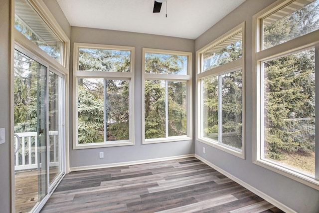 unfurnished sunroom featuring a ceiling fan