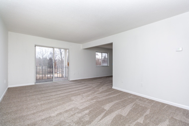 carpeted spare room with baseboards