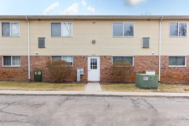 exterior space featuring brick siding