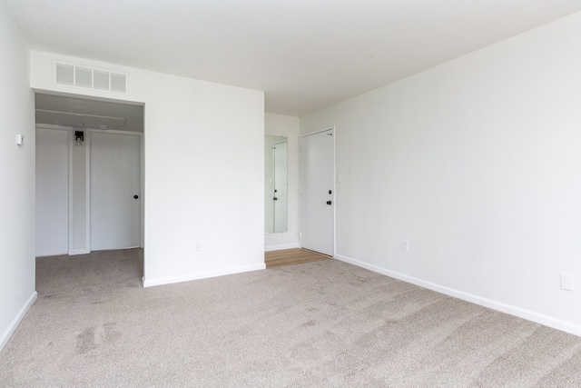 unfurnished bedroom featuring baseboards, visible vents, and carpet flooring