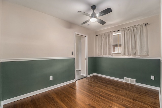 empty room with visible vents, baseboards, and wood finished floors