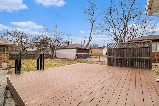 wooden terrace with a fenced backyard, a yard, and an outdoor structure