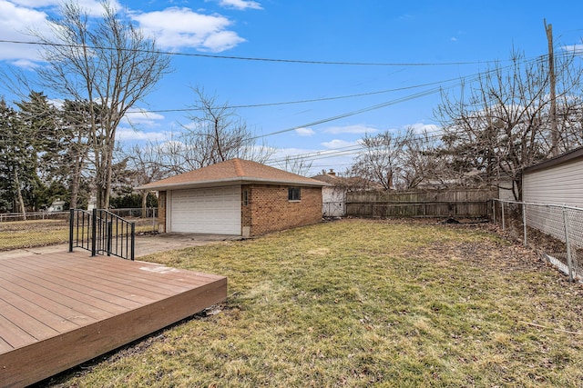 view of yard with a garage, a deck, an outdoor structure, and a fenced backyard