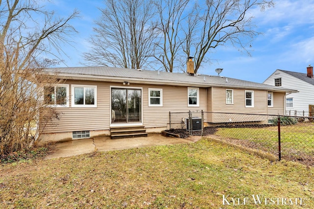 rear view of house featuring a lawn, central AC unit, entry steps, a patio area, and fence