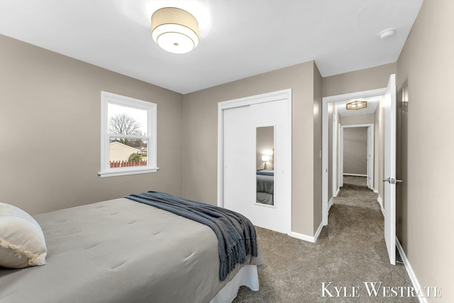 bedroom with carpet, baseboards, and a closet