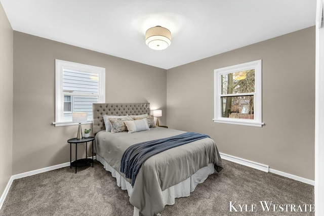 bedroom with carpet floors, a baseboard radiator, multiple windows, and baseboards