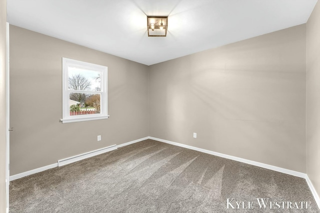 carpeted spare room with a baseboard heating unit and baseboards