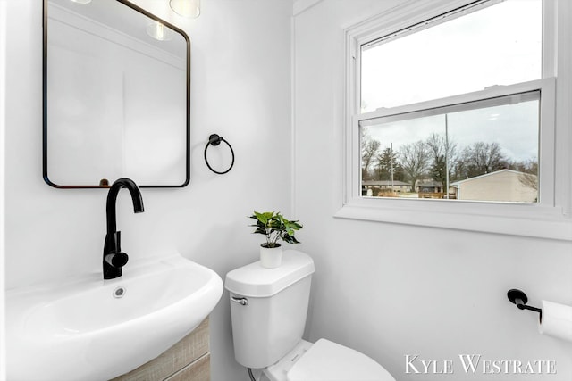 half bathroom with toilet and a sink