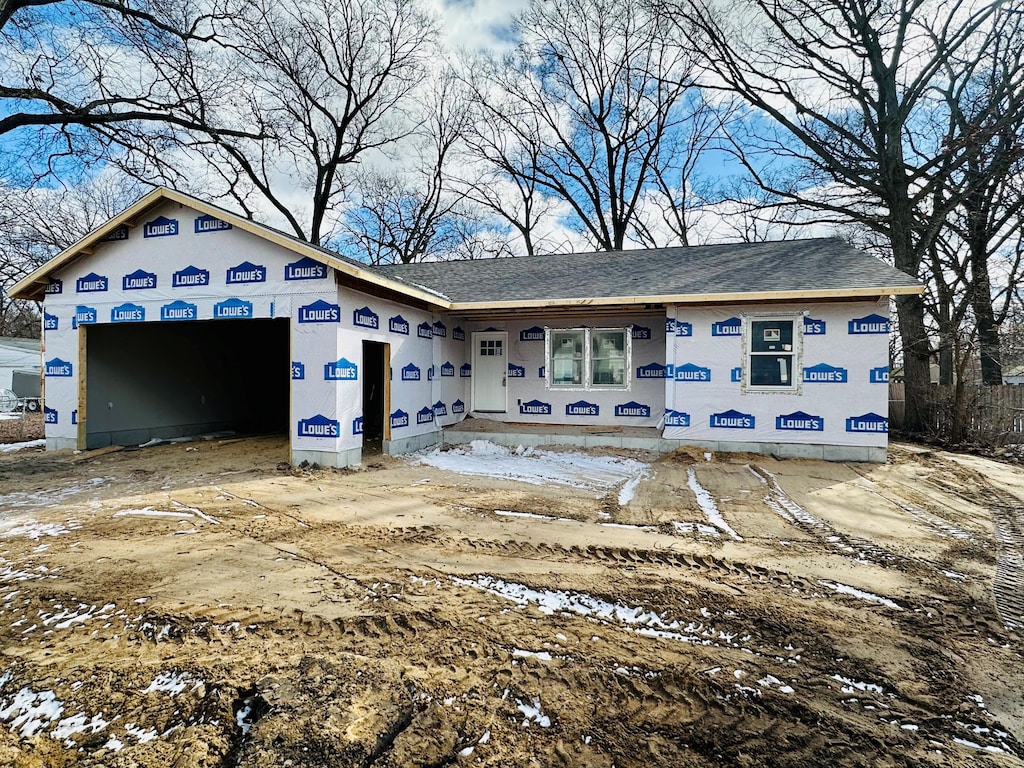 unfinished property featuring an attached garage