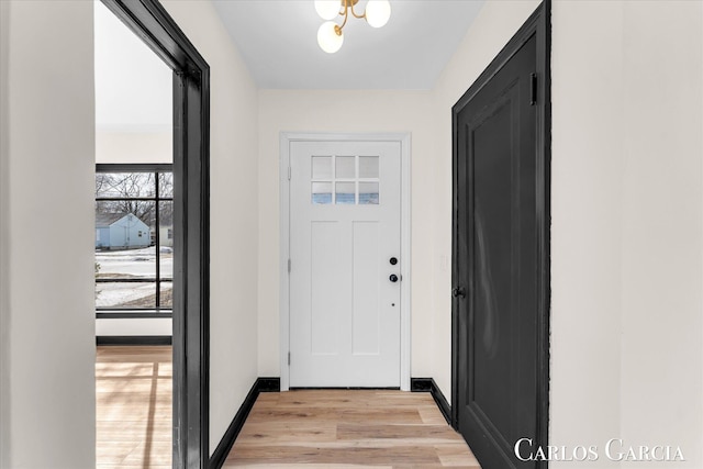 entryway featuring light wood-style flooring and baseboards