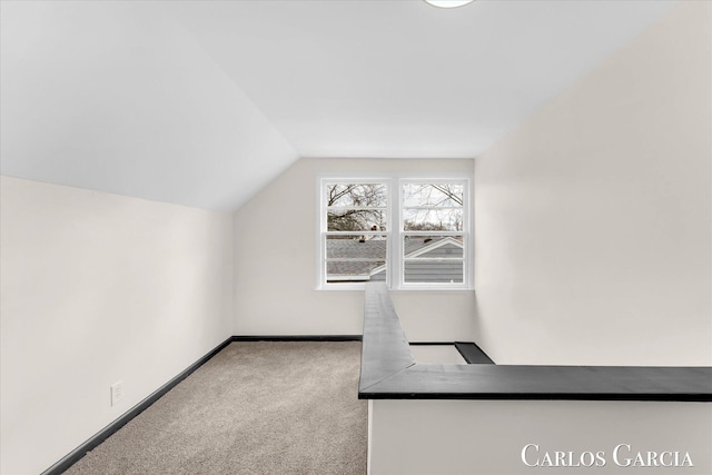 bonus room with lofted ceiling, carpet, and baseboards