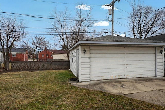 detached garage featuring fence