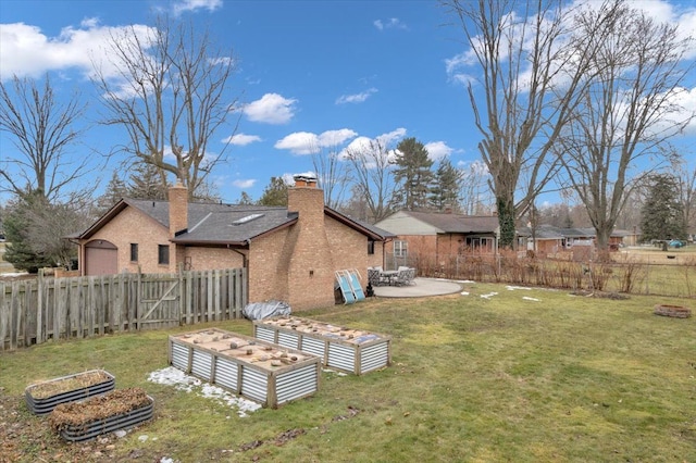 view of yard with a garden, fence, and a patio