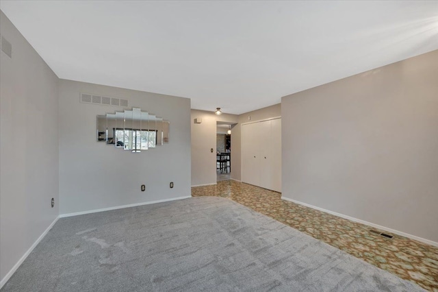 empty room featuring visible vents and baseboards