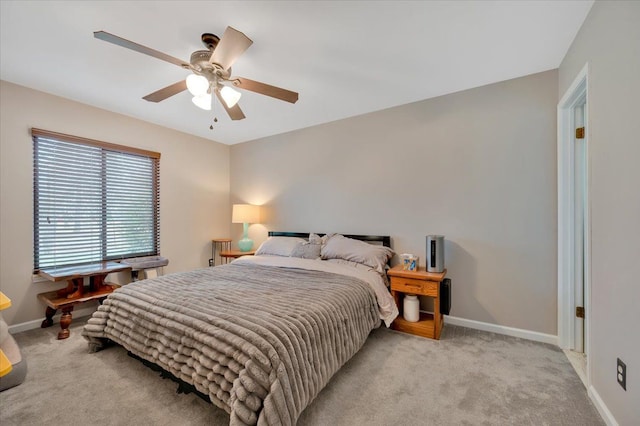 bedroom with baseboards, a ceiling fan, and light colored carpet