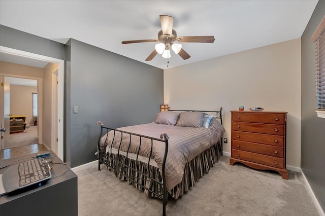 carpeted bedroom featuring a ceiling fan and baseboards