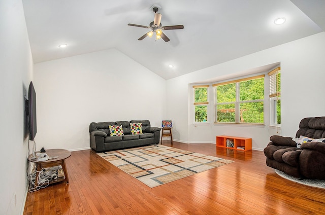 living room featuring recessed lighting, hardwood / wood-style floors, a ceiling fan, vaulted ceiling, and baseboards