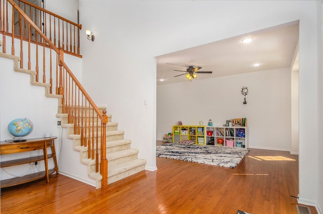 rec room featuring ceiling fan, recessed lighting, wood finished floors, and baseboards