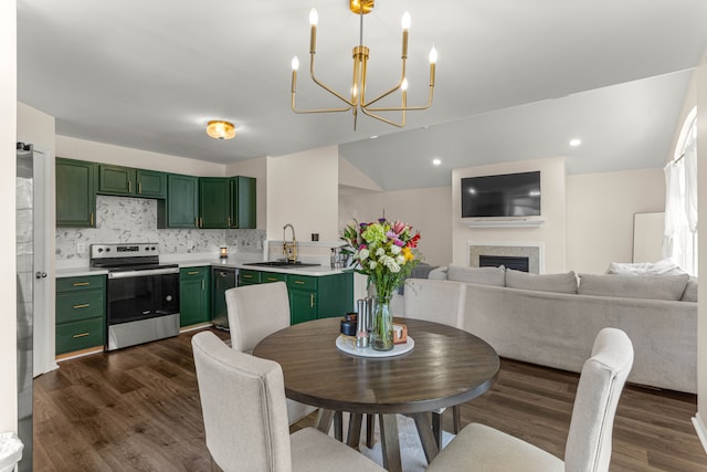 dining area with recessed lighting, a chandelier, dark wood-style flooring, and a fireplace